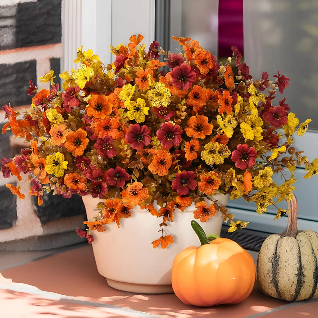 Artificial flower bouquet in autumn colours made from plastic and silk materials.