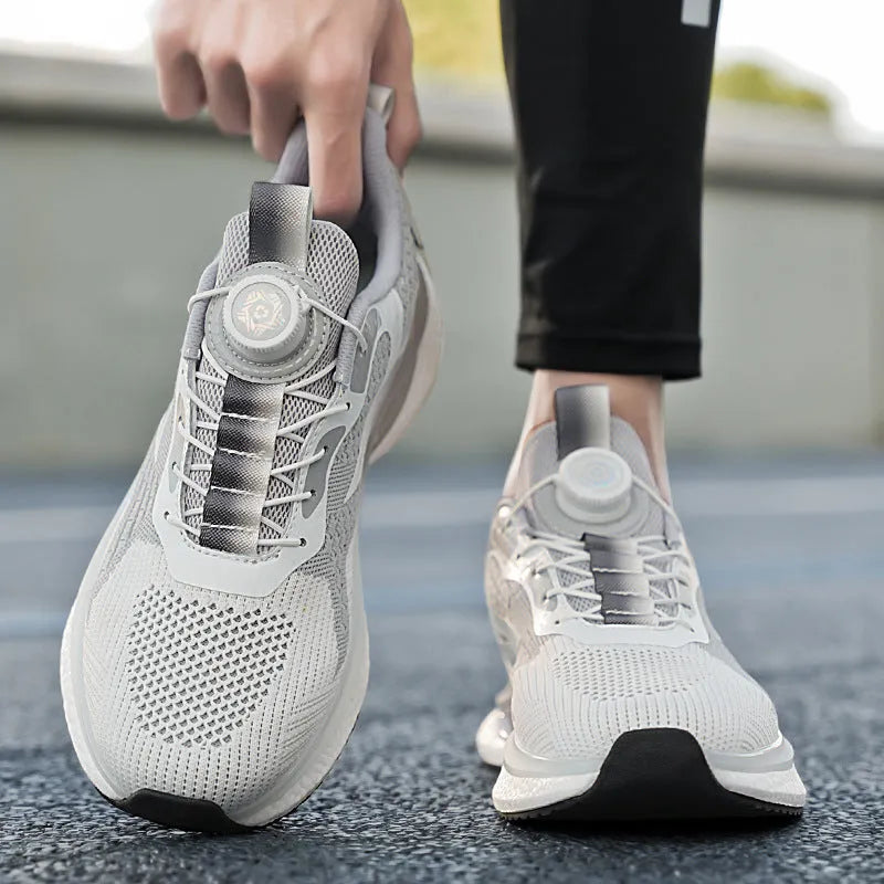 Low-top white running shoes with a rotating button buckle on a breathable mesh upper and a textured TPU sole.