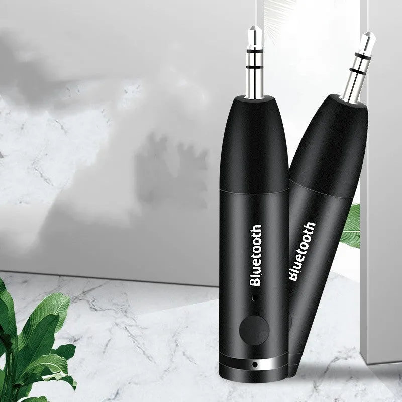 Black Bluetooth audio receiver with AUX connector and USB charging port