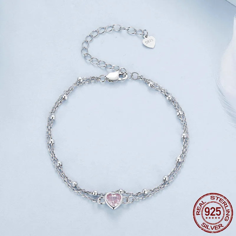 Women's sweet style sterling silver bracelet with small heart pendant on an adjustable chain.