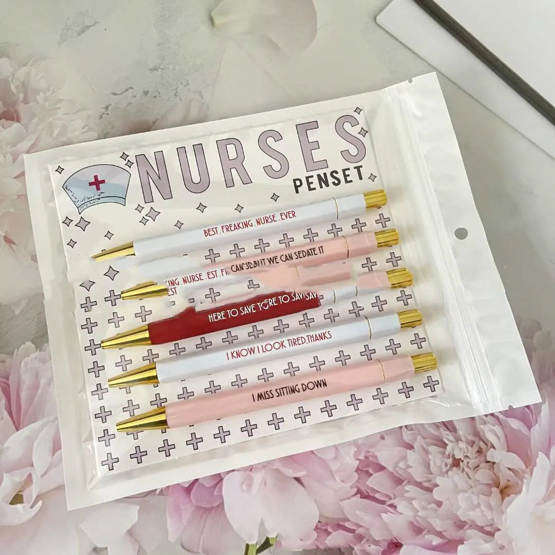 Set of five plastic retractable ballpoint pens with nurse-themed designs on the barrels.