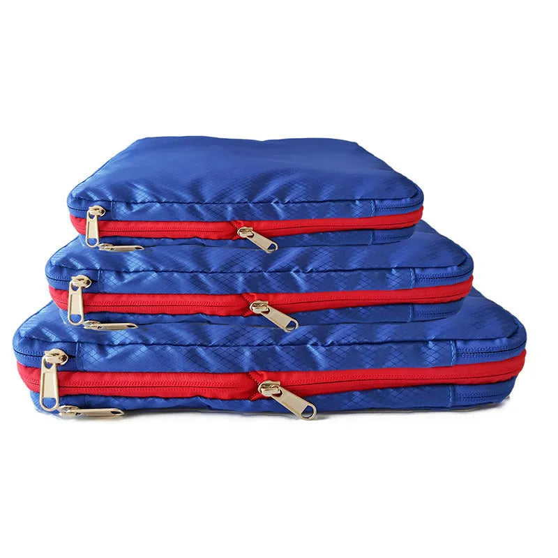 Green travel compression storage bag made of waterproof nylon in cube shape on a white background