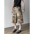 Yellow cotton denim jeans with snake camouflage pattern and cropped leg length.