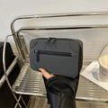 A small, square, structured crossbody bag in a choice of colours, showing its horizontal shape and sewing line detailing.