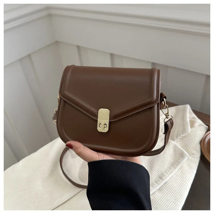 Soft PU leather clamshell messenger bag in a horizontal square shape on a shoulder strap.