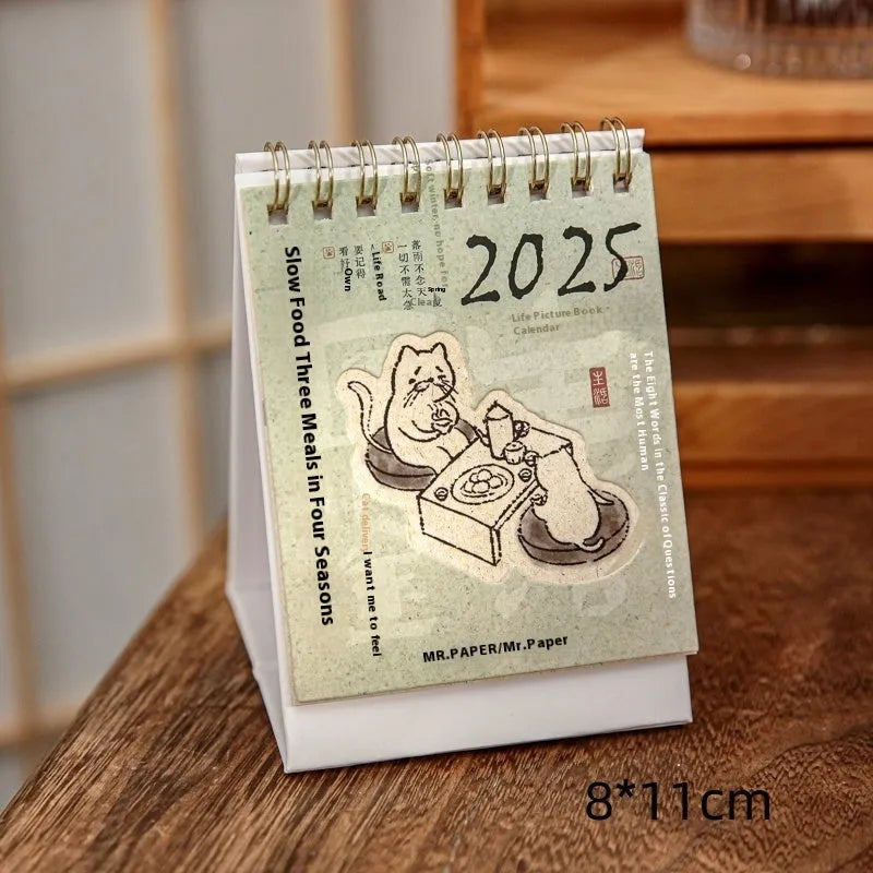 Mini coffee desk calendar 2025 with four design options on small desk surface