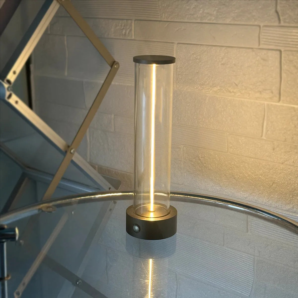 Slim modern glass LED bar night light with magnetic base on a desk surface.