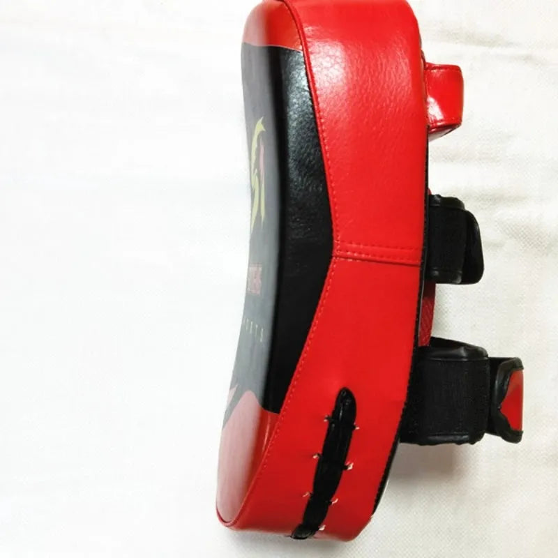 Black with red edges PU leather hand-held boxing target pad showing adhesive buckle strap.