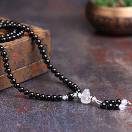 Natural black and red agate 108-bead bracelet with geometric shapes