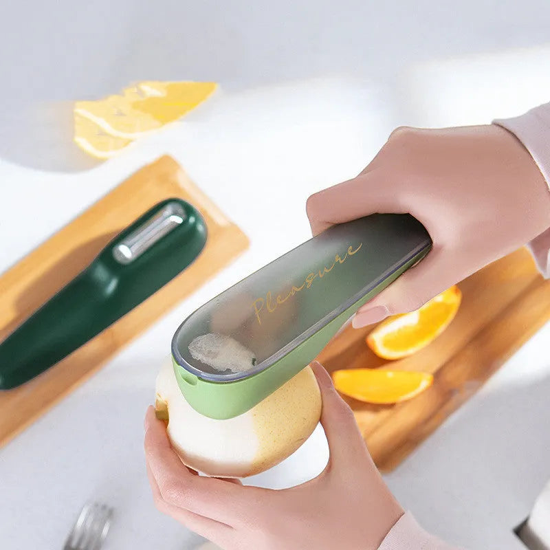 Green fruit and vegetable peeler with a stainless steel blade, plastic handle, and a separate white storage tube.
