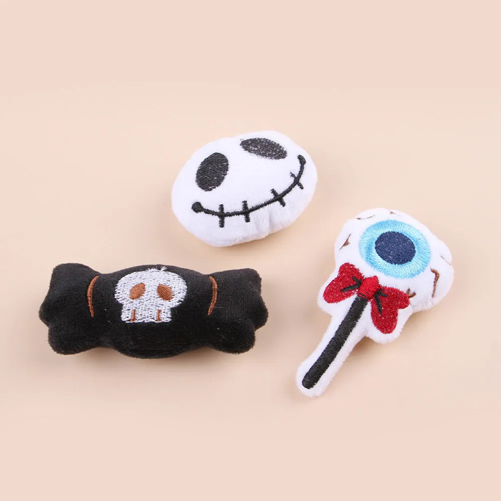 Small colourful plush cat teaser wand with candy, eyes, and skull designs