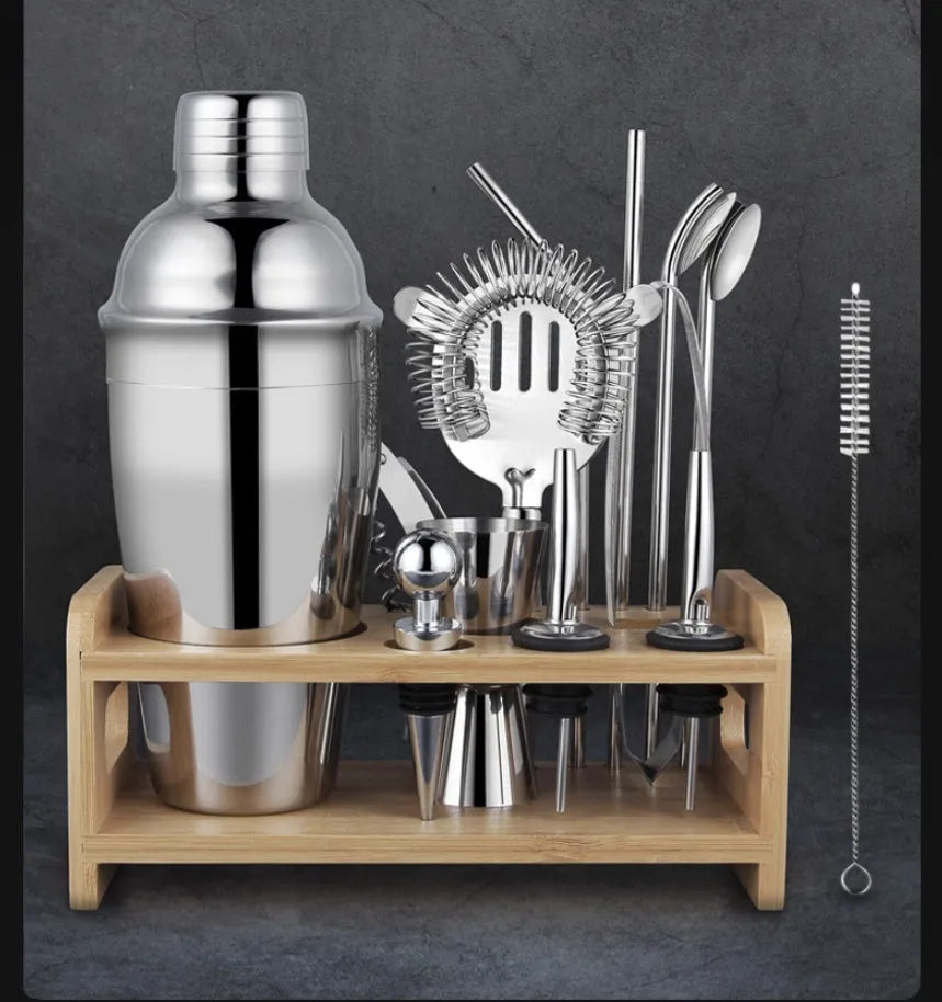 23-piece stainless steel cocktail set with acrylic shakers and bar tools laid out.