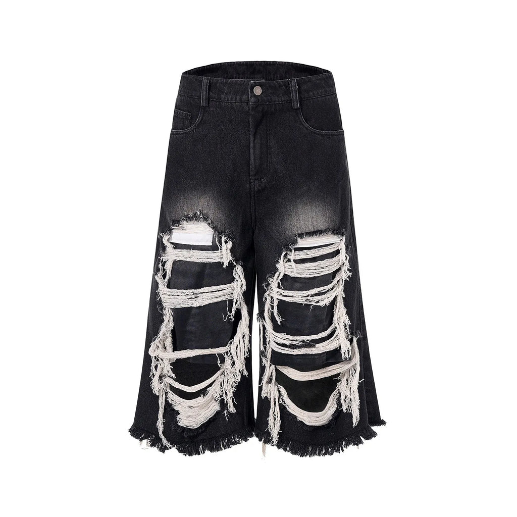 Black cropped wide-leg women's jeans with a ripped patch detail and a mid-high waist.