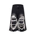 Black cropped wide-leg women's jeans with a ripped patch detail and a mid-high waist.