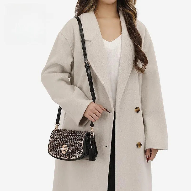Black polyester crossbody underarm chain shoulder bag with chain strap on white background