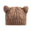 Hand-made red knitted beanie with 3D cat ears on a mannequin head
