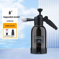 Black handheld 2L foam watering can sprayer with two nozzles and a comfort-grip handle.