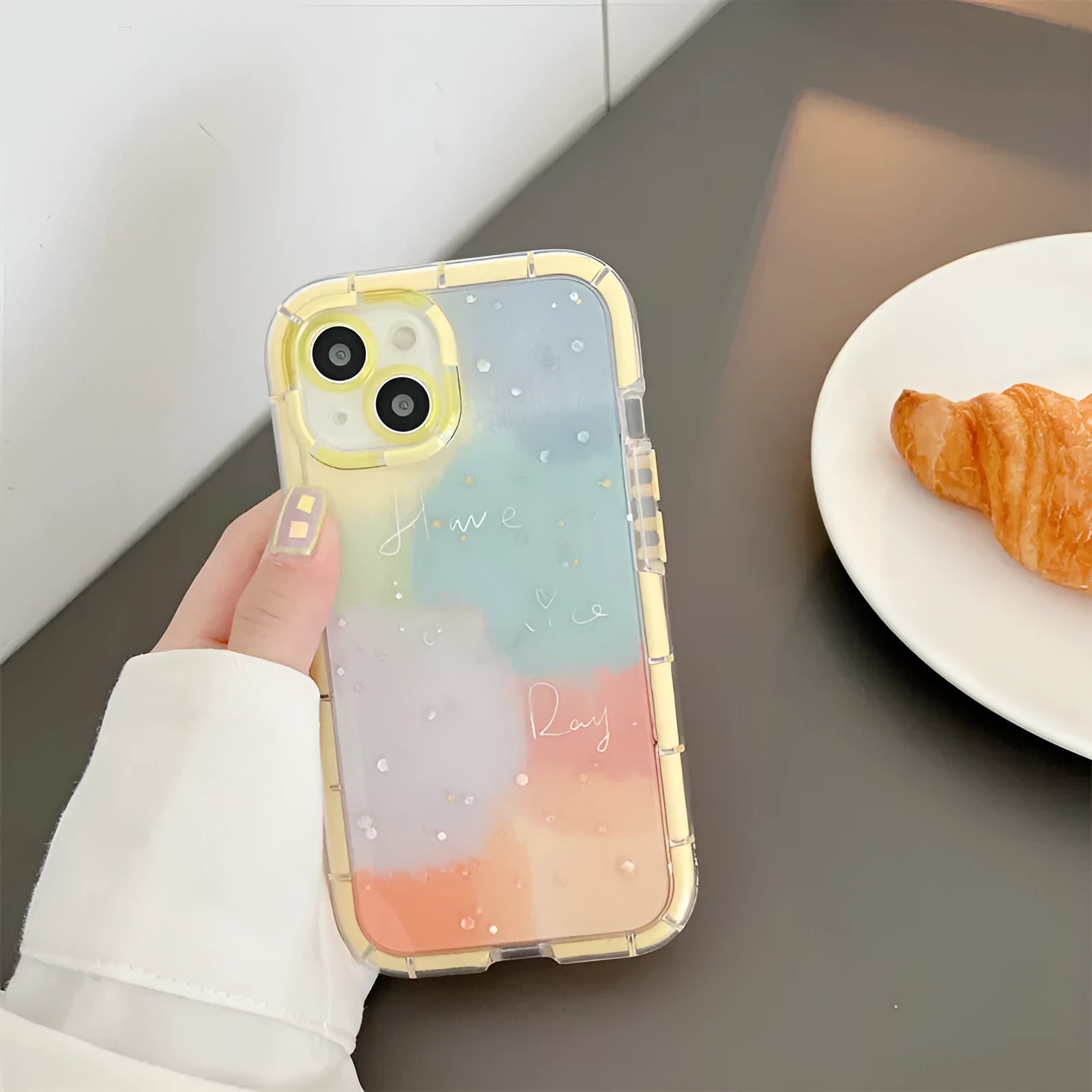 Minimalist iPhone 14 silicone case with a yellow contrast colour edge on a white background.