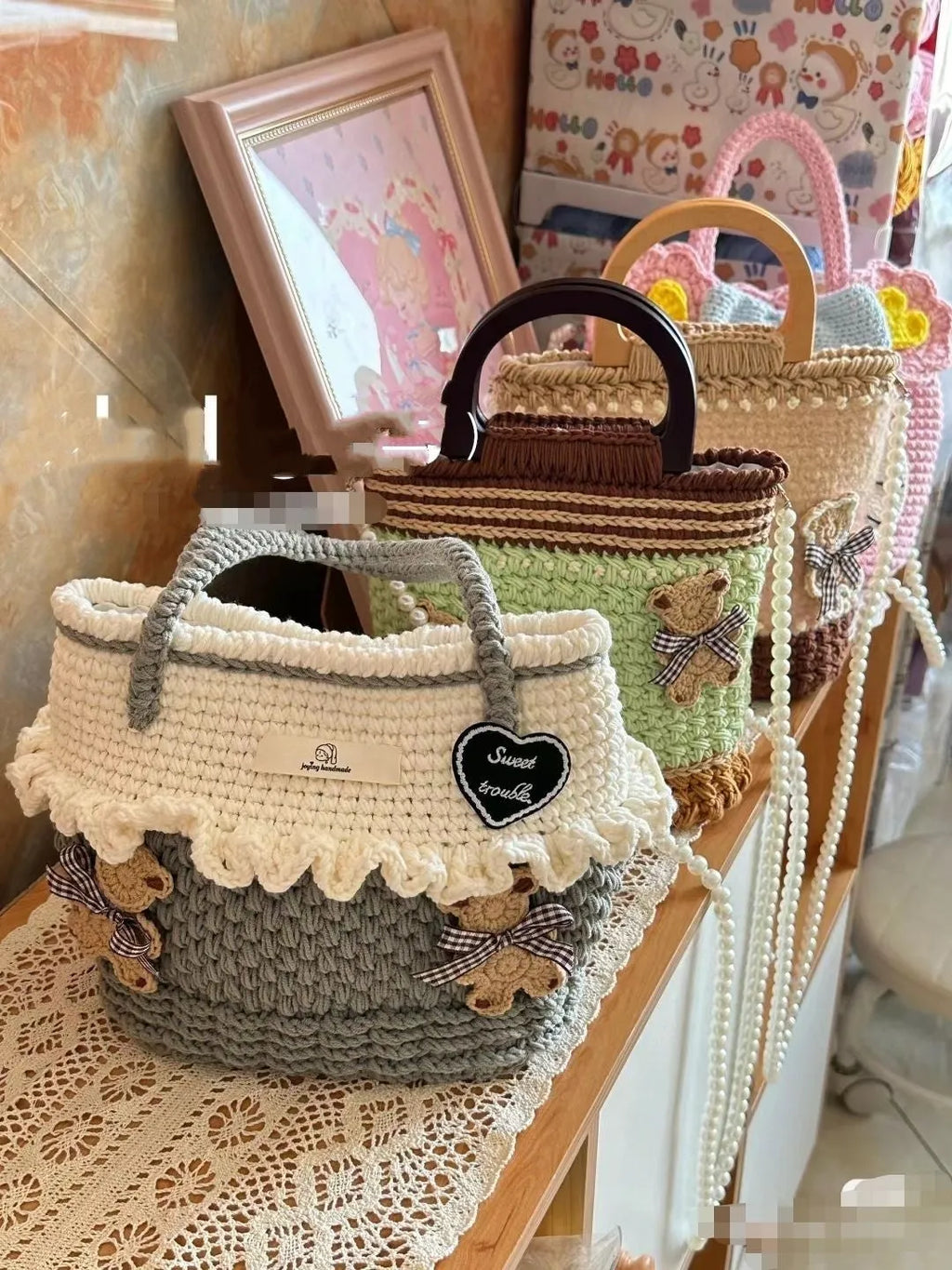 Wool crocheted bear-shaped shoulder bag with a wooden handle in a random colour pattern.