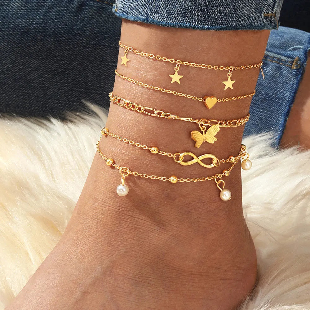 Butterfly pearl heart design four-piece alloy anklet set for women with multi-layer styling options