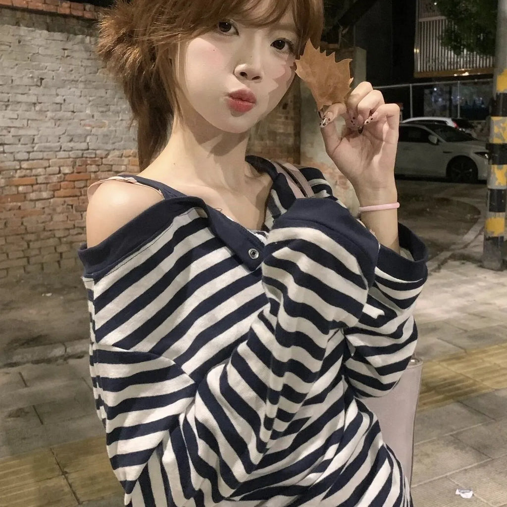 Dark blue oversized long-sleeved women's T-shirt with stripes and embroidery details.