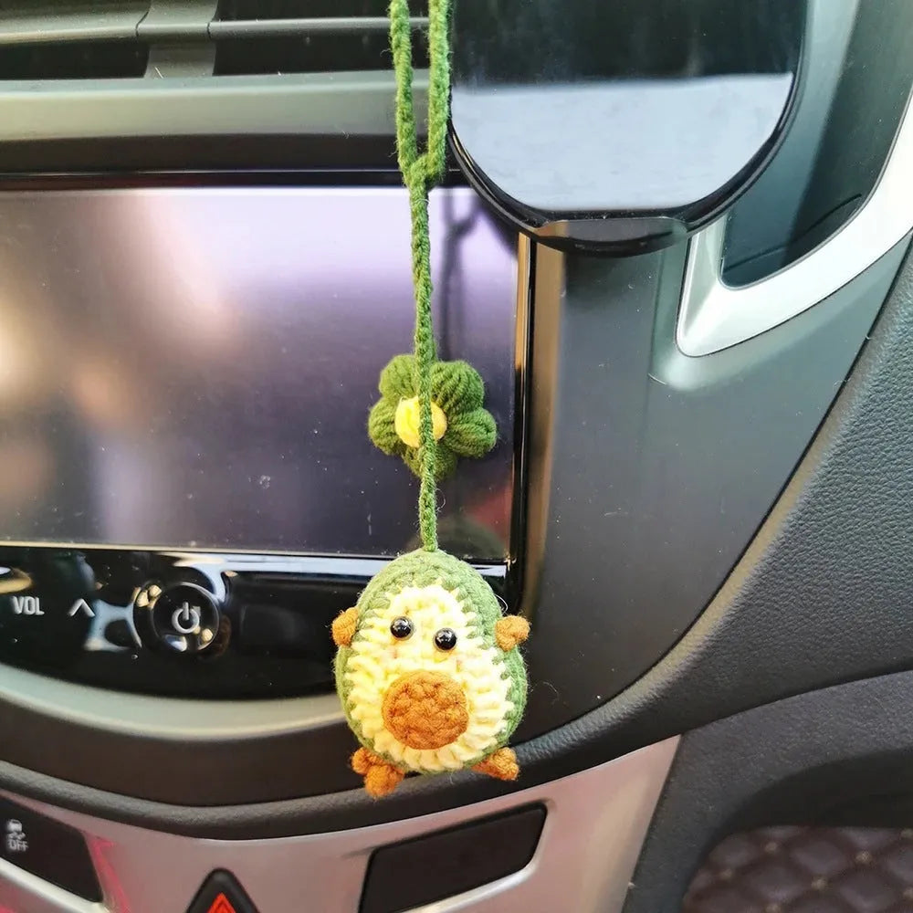Handmade crocheted wool car pendant in avocado, pink rainbow, or red rainbow colour with cartoon flower design.