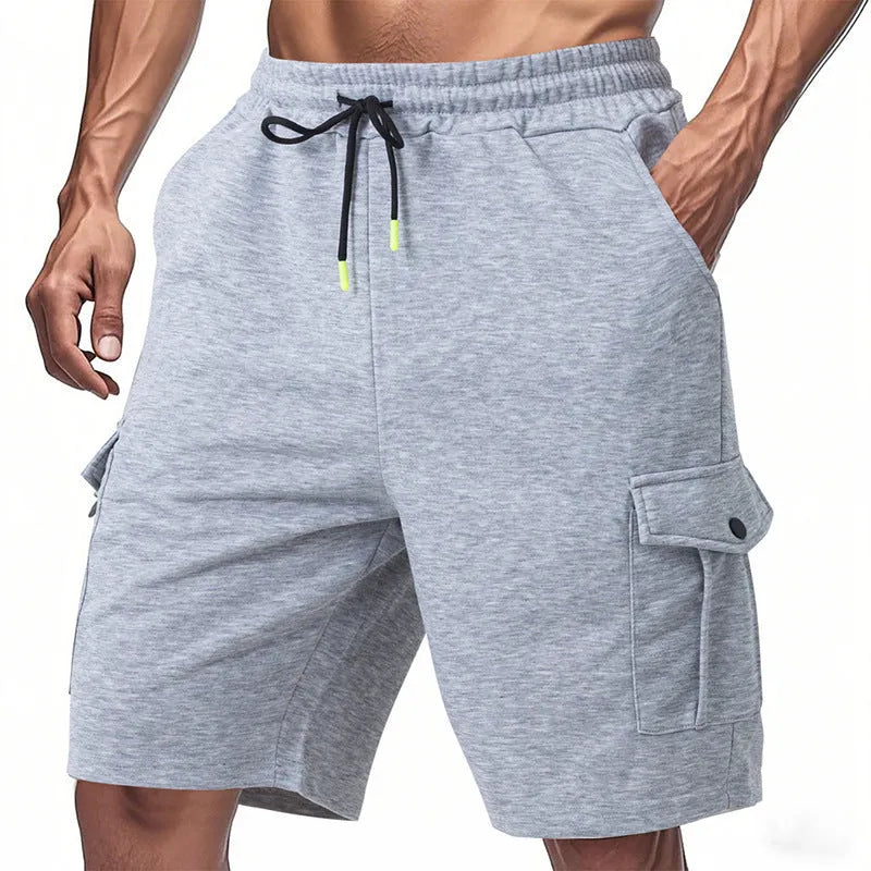 Loose grey terry fabric cargo shorts with multiple pockets on a neutral background