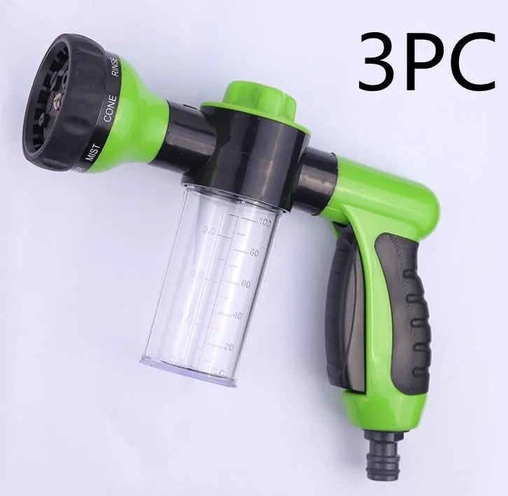 Green high-pressure foam spray gun with adjustable nozzle and attached water hose for car and garden cleaning.