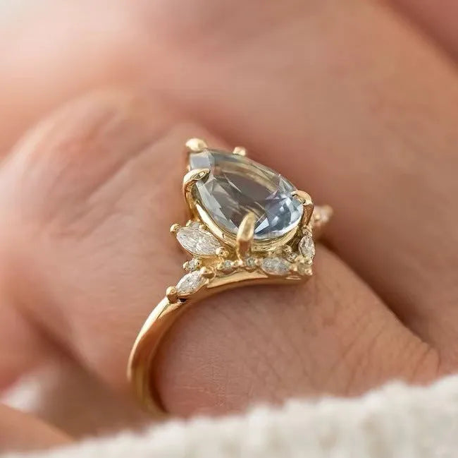 Gold-tone alloy floral ring with blue aquamarine-coloured crystal and diamond inlay for women