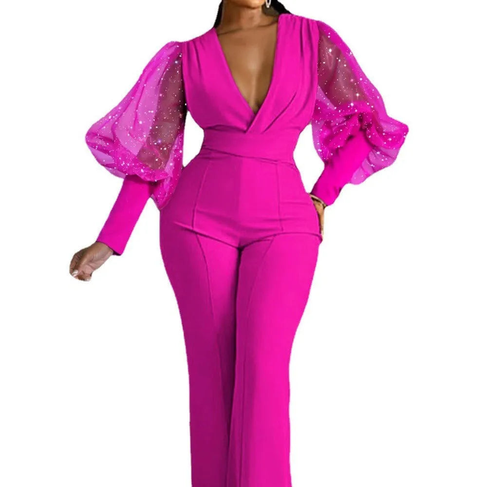 Red women's long sleeve jumpsuit with slim fit, wide leg trousers, and mesh stitching detail on the sleeves.