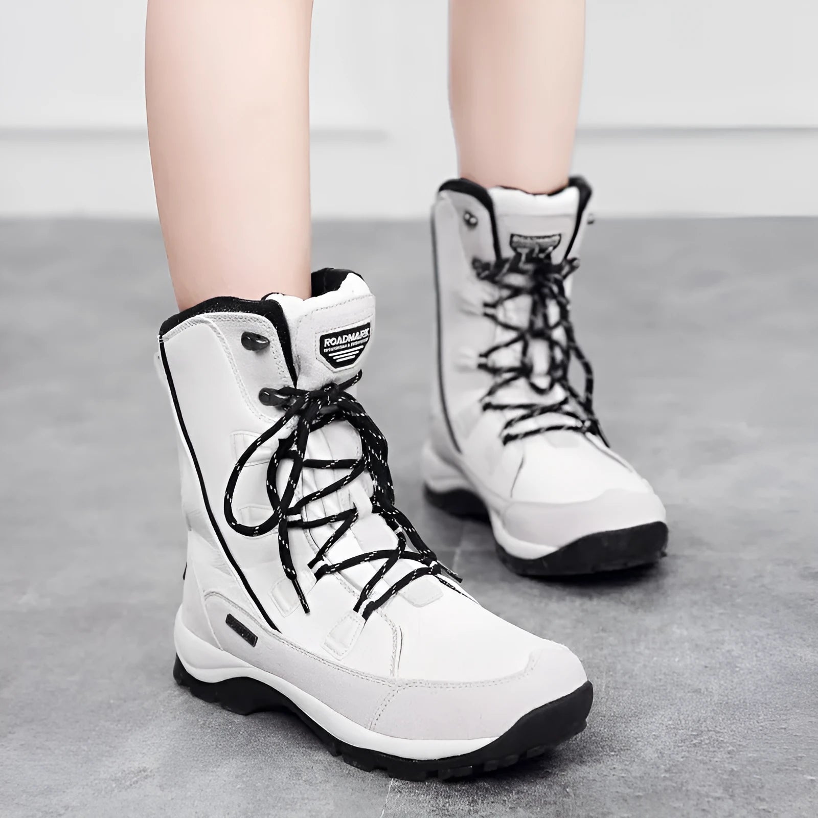 Women's black mid-calf thermal snow boots with a round toe and genuine leather upper on a rubber sole.