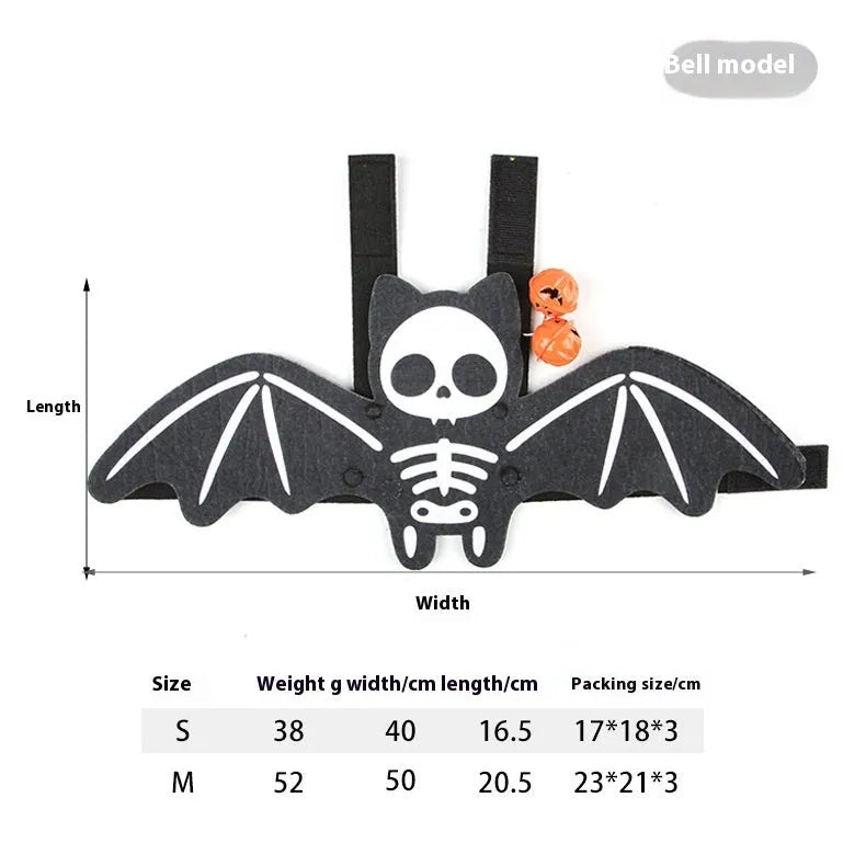 Black cat wearing an orange felt batwing Halloween costume with bell.