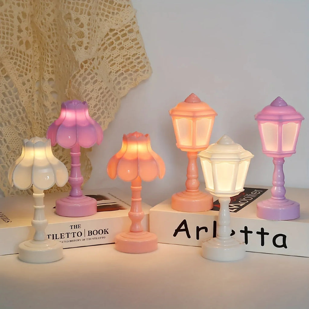 Small geometric retro pagoda night lamp in light purple, shown on a wooden surface.
