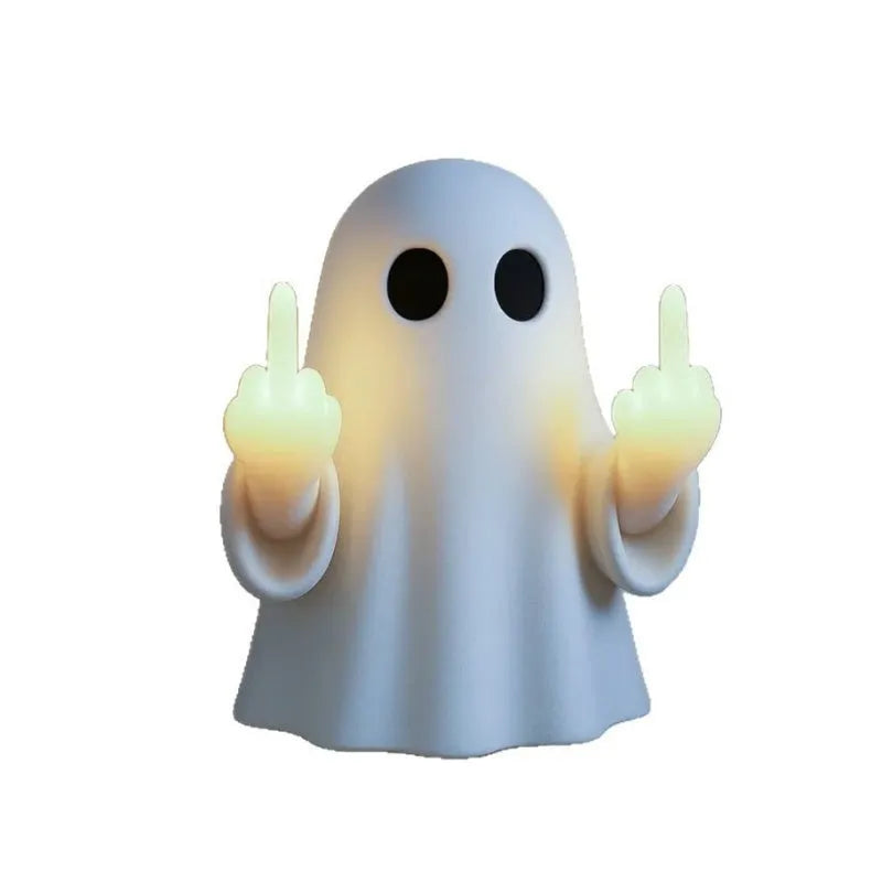 White cute ghost statue plastic night lamp for Halloween decoration on a dark surface.