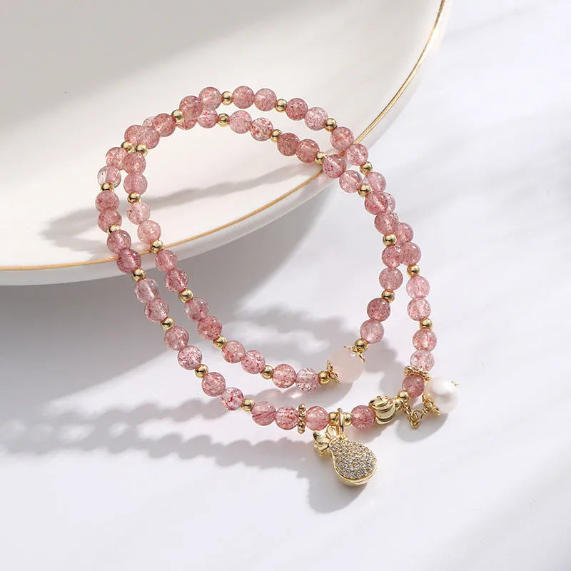 Women's strawberry quartz crystal bracelet with geometric shapes for money drawing