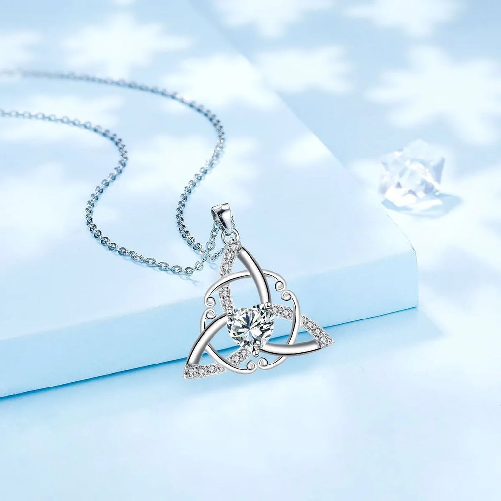 Women's Celtic knot geometric pendant necklace in copper with electroplated blue finish.