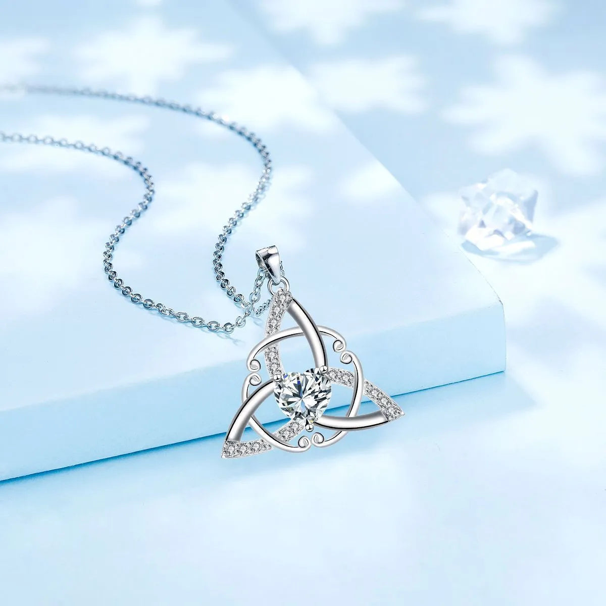 Women's Celtic knot geometric pendant necklace in copper with electroplated blue finish.