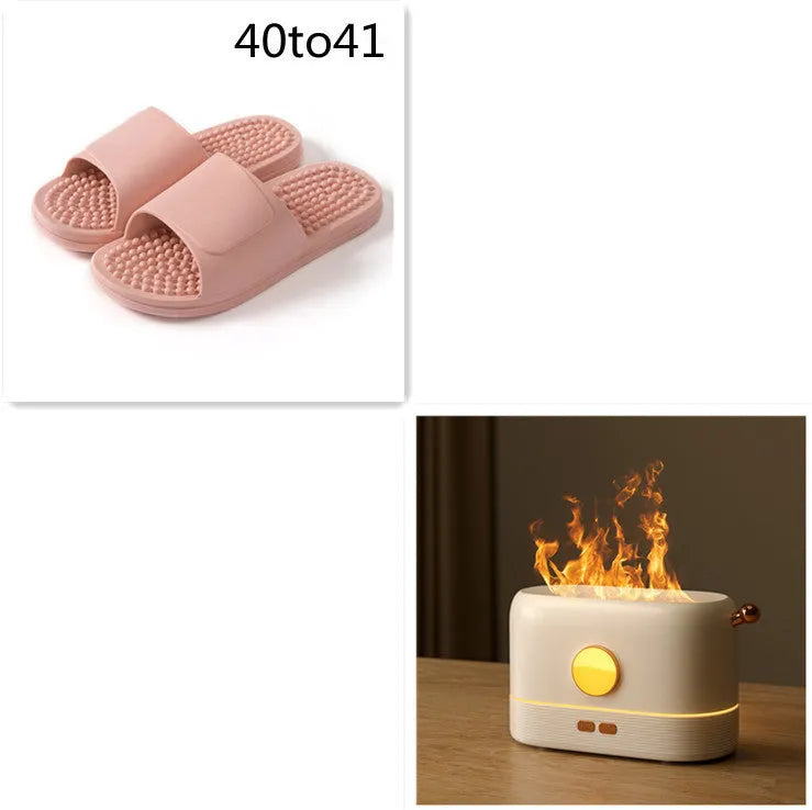 Black USB humidifier diffuser with flickering flame effect light and water mist on wooden desk