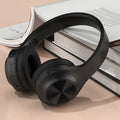 Creative wireless Bluetooth headset in Chalk Black colour with charging case on a table.