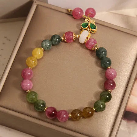 Women's tourmaline bracelet with colourful butterfly pendant and rhinestone detailing on adjustable chain