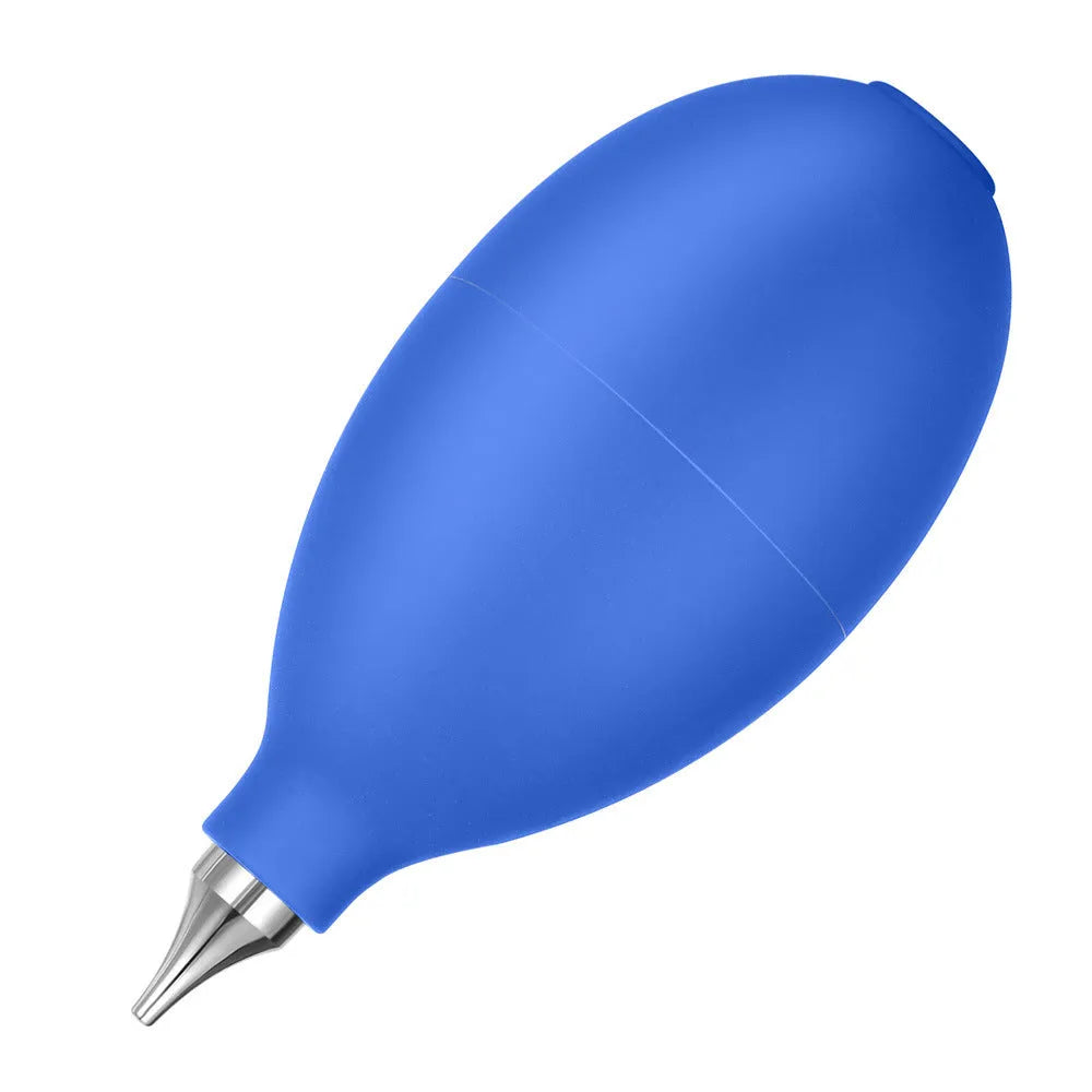 Blue hand-held rubber dust blower cleaning tool with tapered nozzle, shown next to a mobile phone for scale