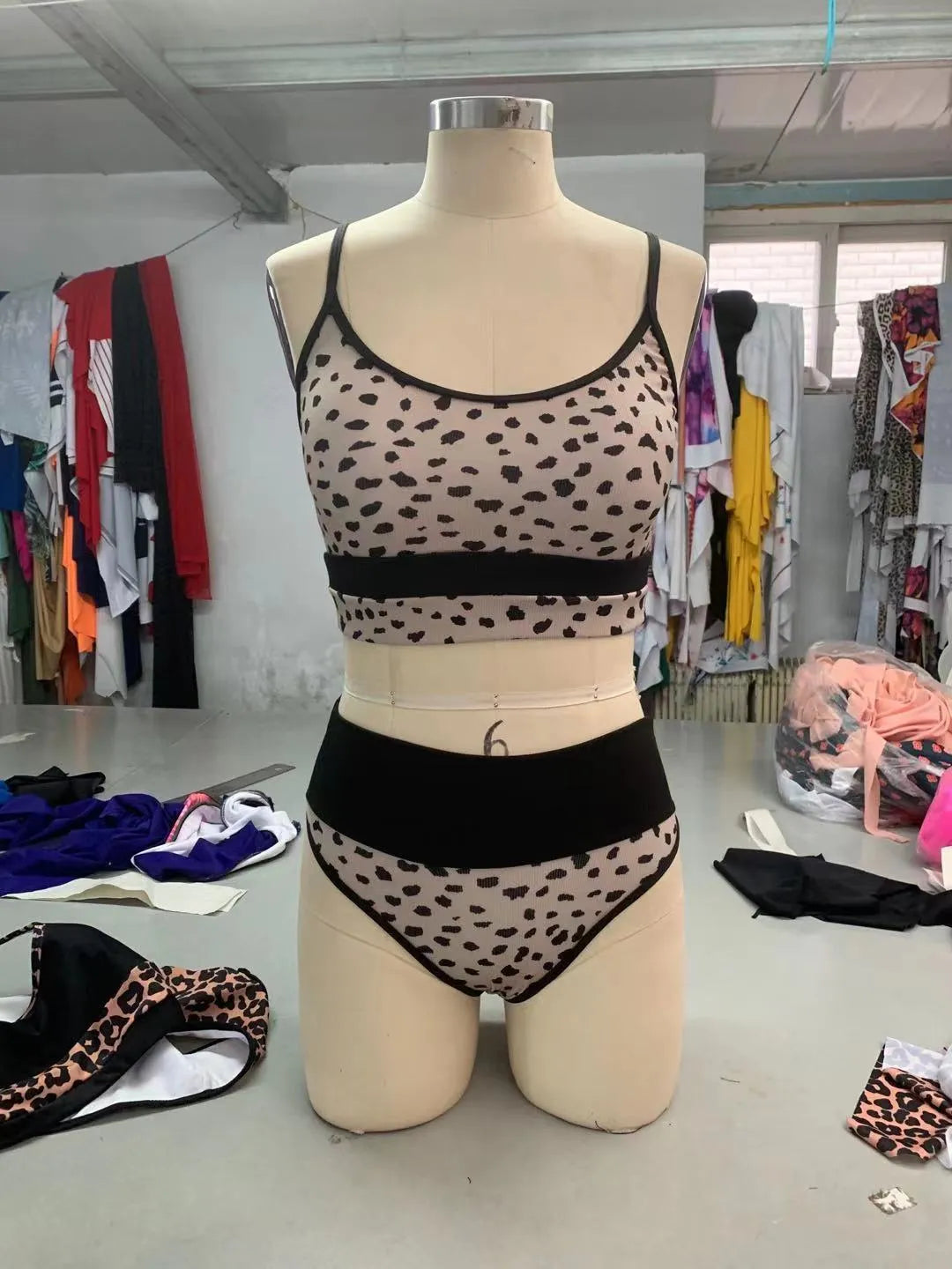 Women's high-waist split bikini swimsuit in leopard print and white colour options.