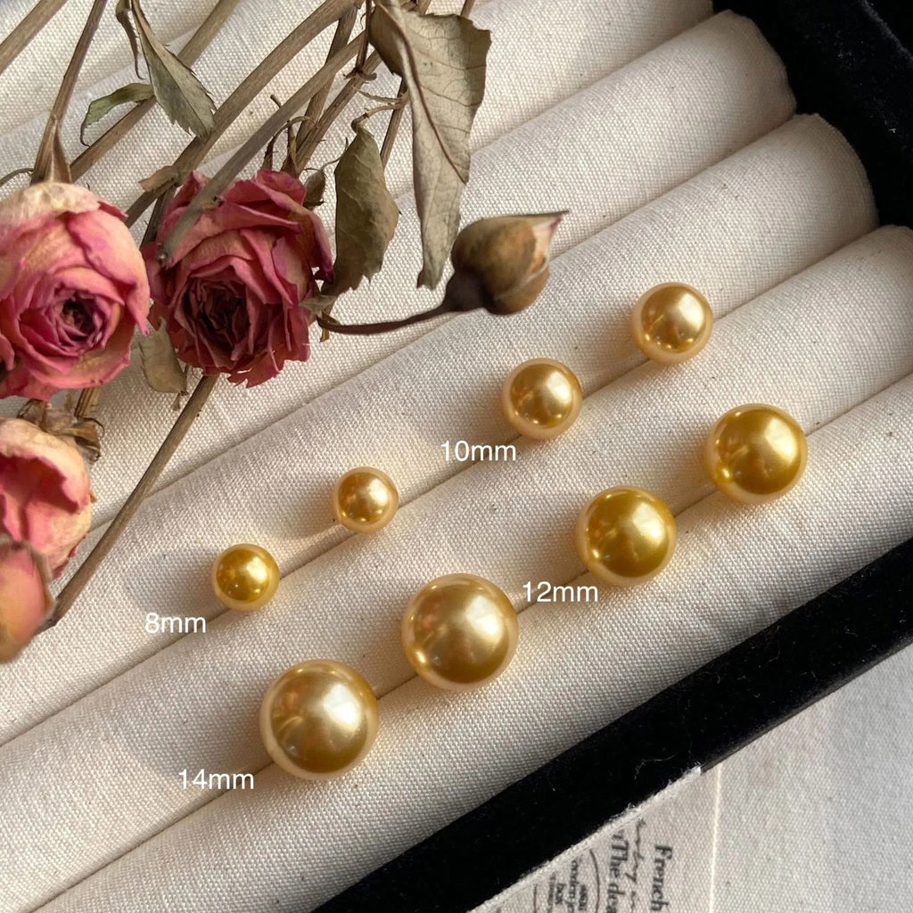 Large geometric pearl stud earrings for women with an eight-point star detail on a silver setting.