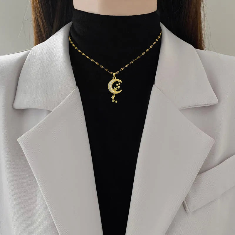 Moon Tassel Necklace showing geometric copper pendant with diamonds and tassel on a stainless steel chain.