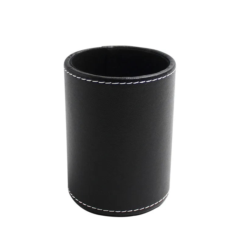 Small round black leather pen holder on a desk
