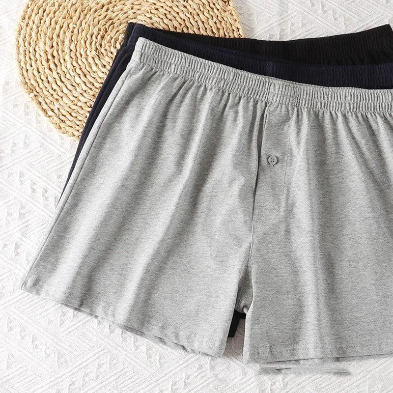 Men's light grey high-waist cotton loose boxer shorts laid flat.