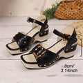 Women's white buckle-strap sandals with a chunky heel and metal clasp on a plain background.