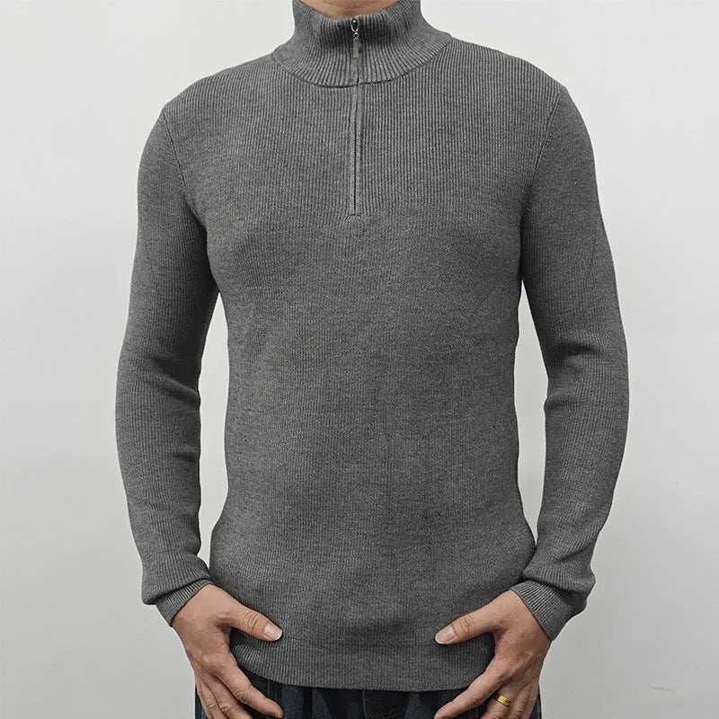 Man wearing a grey half-turtleneck zip-front sweater, a cotton blend pullover for casual wear.