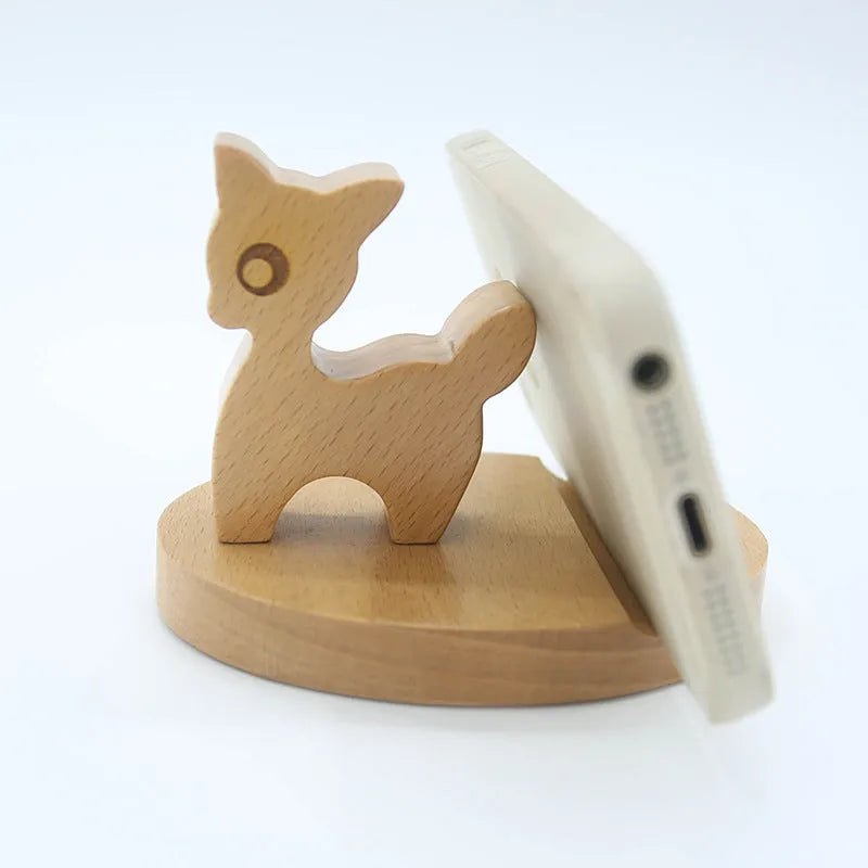 Solid beech wood phone holder with resin puppy decoration and a pound coin in the integrated slot.