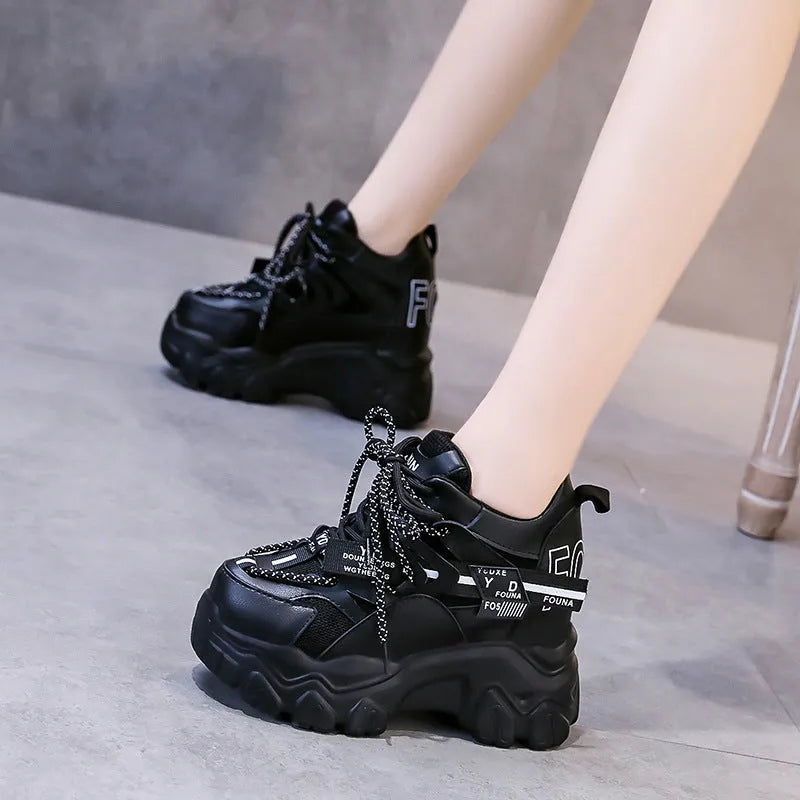 White women's low-top platform sports shoes with cross-strap detail on a rubber sole.